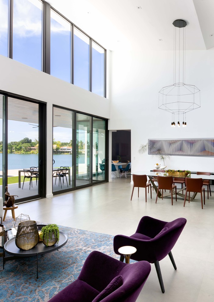 Photo of a large contemporary open plan dining room in Miami with white walls, porcelain flooring and grey floors.