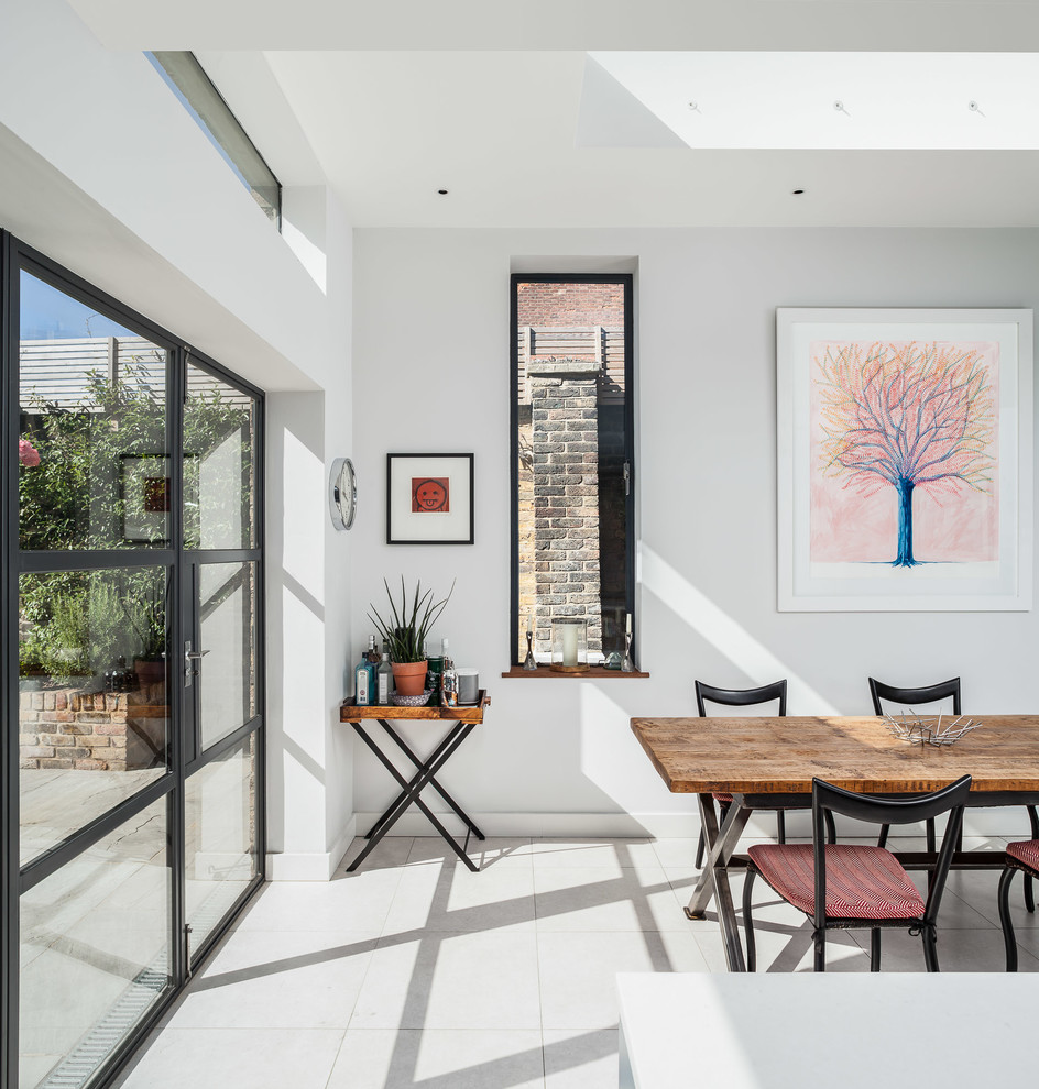 Photo of a contemporary dining room in London with white walls.