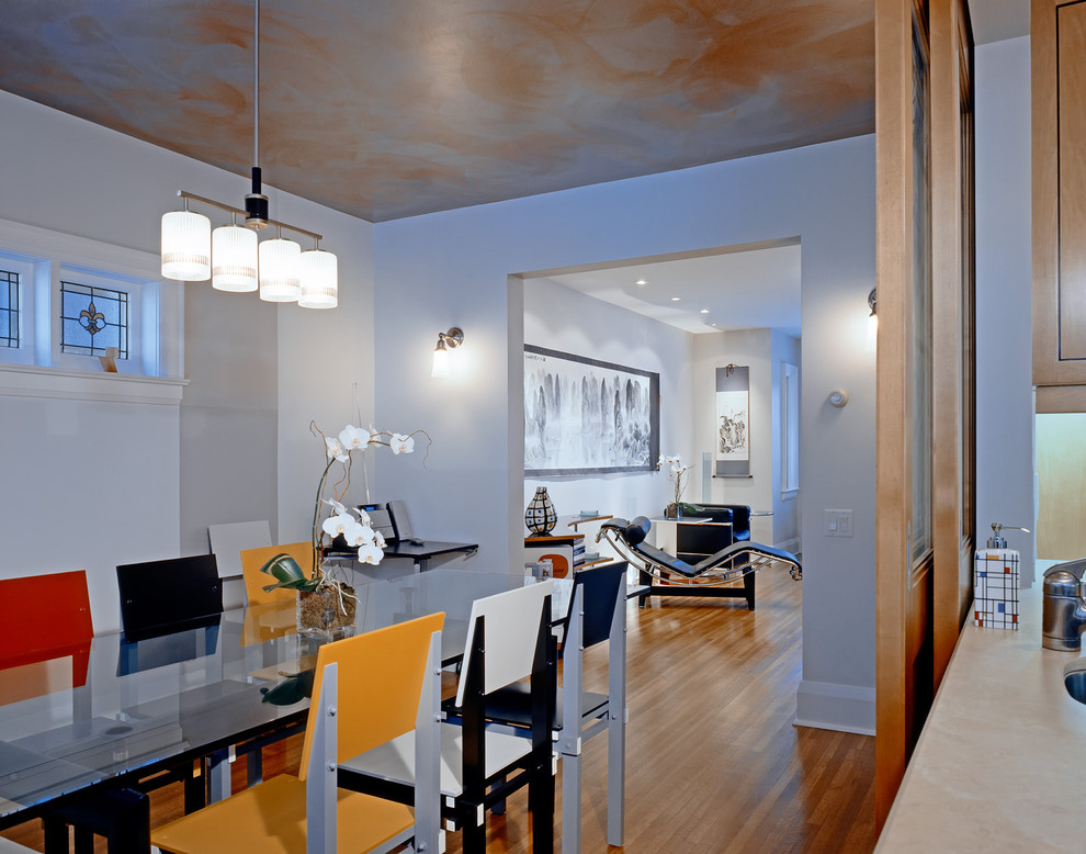 Contemporary dining room in Toronto with grey walls and medium hardwood flooring.