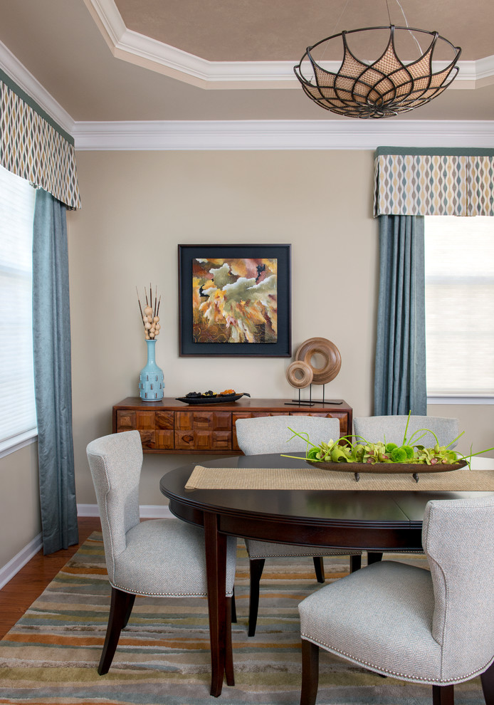 Enclosed dining room - small traditional medium tone wood floor enclosed dining room idea in Newark with beige walls and no fireplace