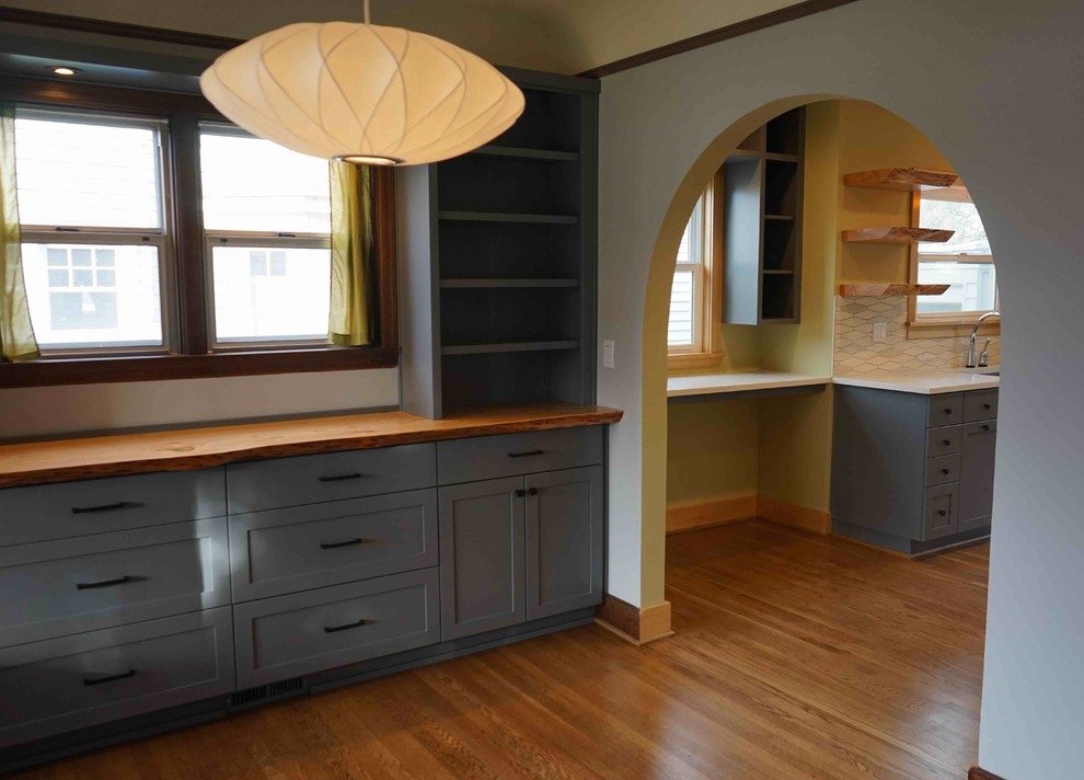 Ejemplo de comedor minimalista de tamaño medio cerrado con paredes grises y suelo de madera en tonos medios