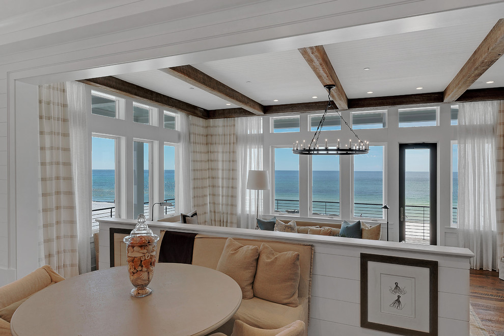 Photo of an expansive beach style dining room in Miami with white walls, dark hardwood flooring and no fireplace.