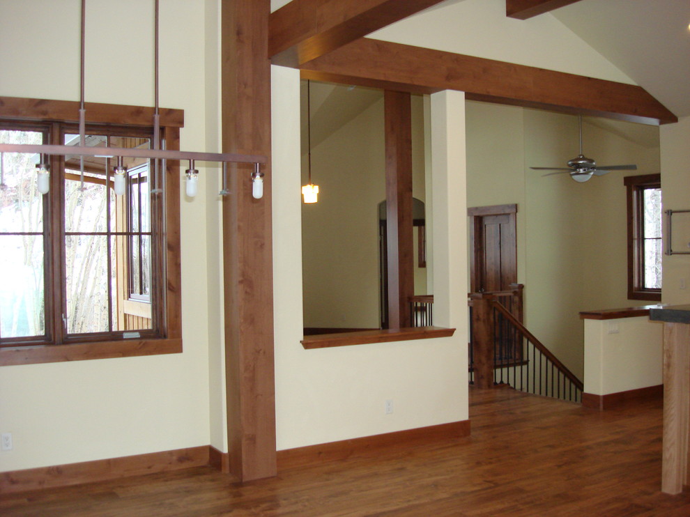 Large mountain style medium tone wood floor great room photo in Denver with beige walls