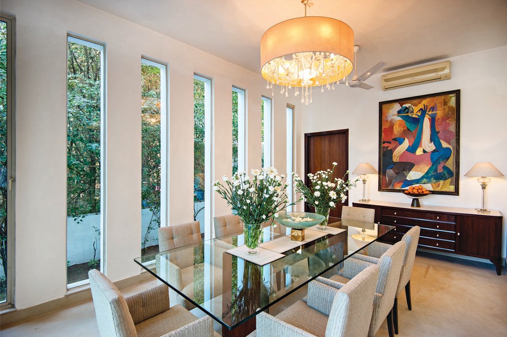 Mid-sized trendy enclosed dining room photo in Mumbai with white walls and no fireplace