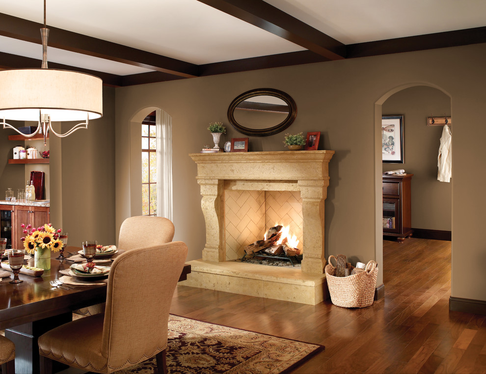 Enclosed dining room - mid-sized traditional dark wood floor and brown floor enclosed dining room idea in Sacramento with beige walls, a standard fireplace and a stone fireplace