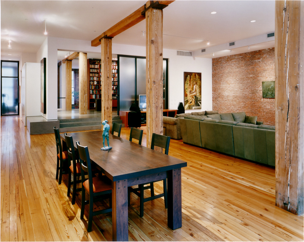 Large contemporary open plan dining room in New York with white walls and light hardwood flooring.