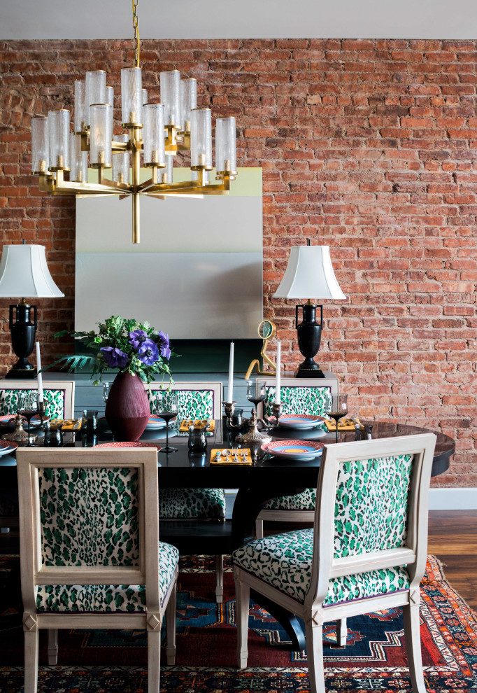 Transitional dark wood floor, brown floor and brick wall dining room photo in Boston with red walls