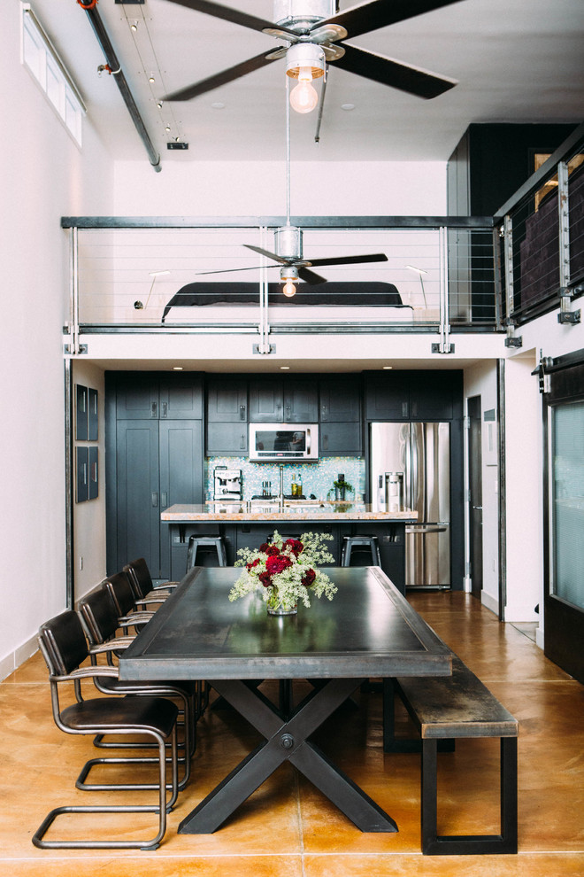 Large urban concrete floor kitchen/dining room combo photo in Los Angeles with white walls and no fireplace