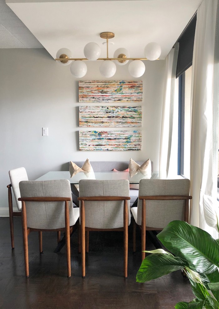 Ispirazione per una piccola sala da pranzo aperta verso il soggiorno moderna con pareti grigie, parquet scuro e pavimento marrone