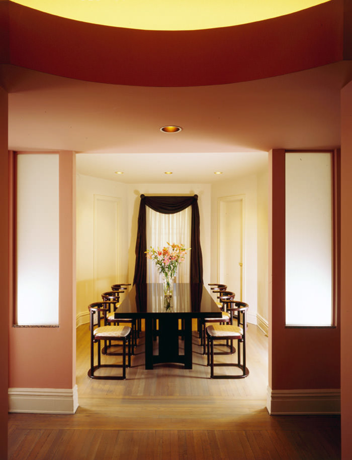Inspiration for a medium sized contemporary enclosed dining room in New York with pink walls and light hardwood flooring.