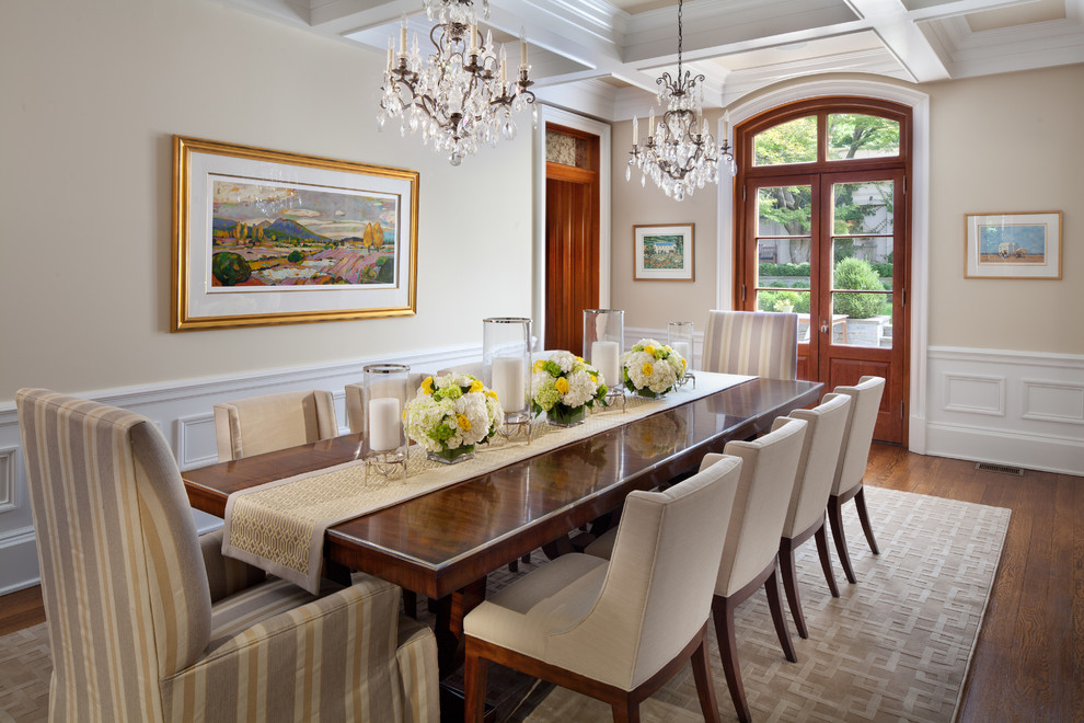 This is an example of a classic dining room in DC Metro with beige walls and dark hardwood flooring.