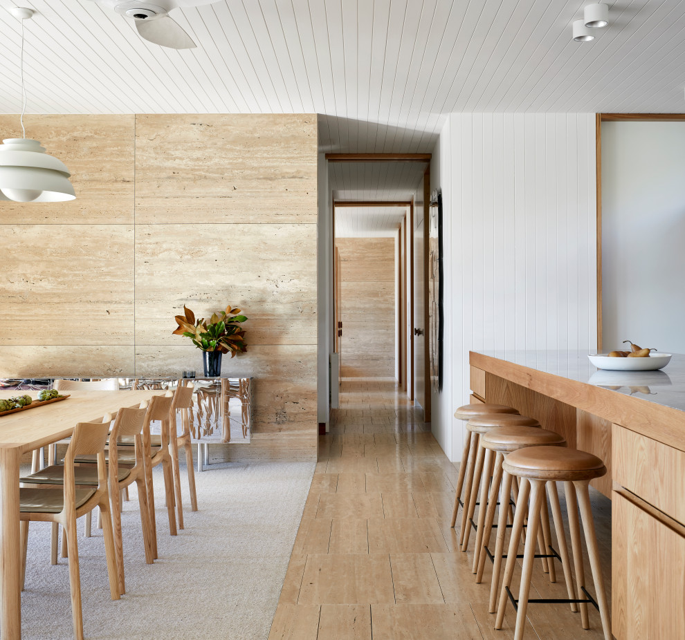 Photo of a medium sized coastal open plan dining room in Melbourne with beige walls, travertine flooring, beige floors, a timber clad ceiling and feature lighting.
