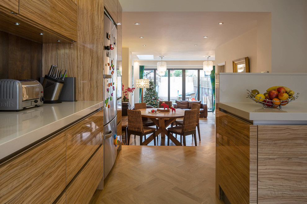 Photo of a medium sized contemporary open plan dining room in London with light hardwood flooring and no fireplace.