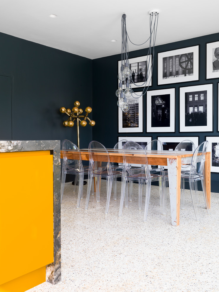 На фото: кухня-столовая среднего размера в современном стиле с черными стенами и разноцветным полом с