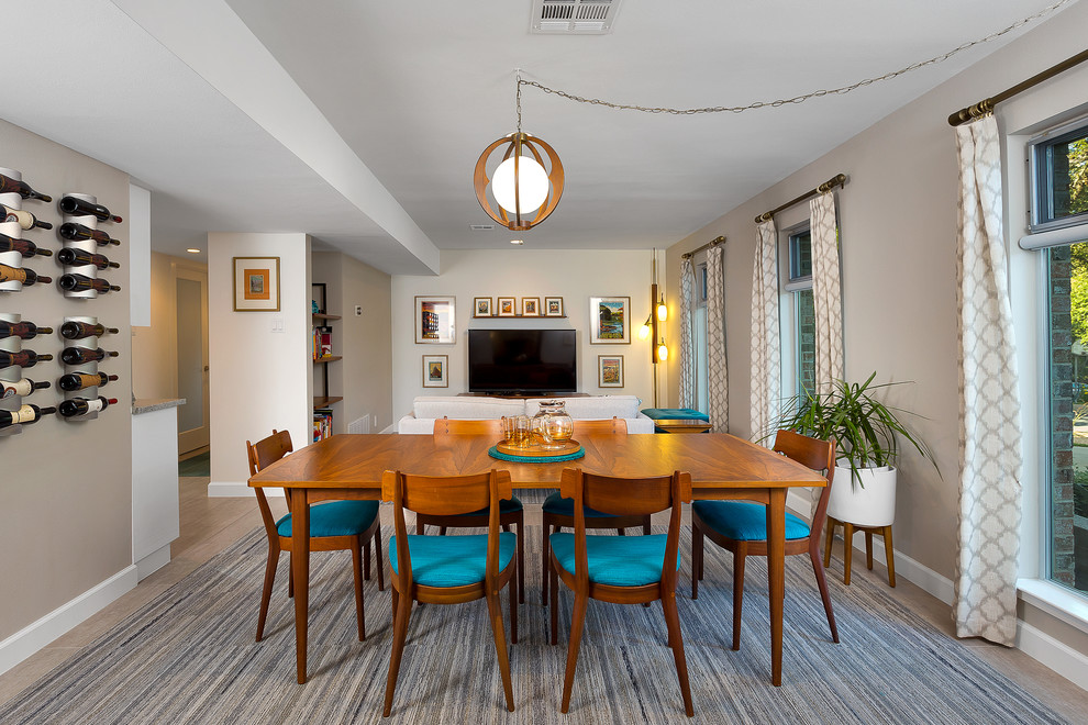 Immagine di una sala da pranzo aperta verso il soggiorno minimalista di medie dimensioni con pareti grigie e pavimento in gres porcellanato