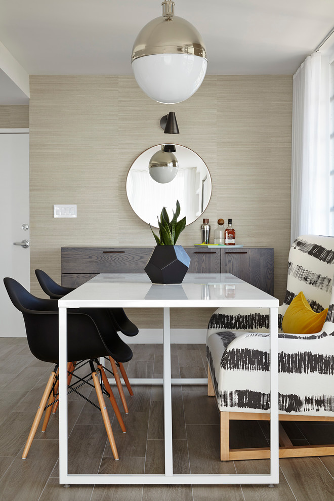 This is an example of a contemporary dining room in Miami with beige walls.