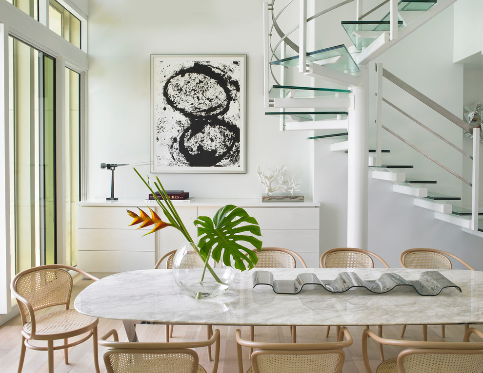 This is an example of a medium sized contemporary dining room in Miami with white walls, no fireplace, light hardwood flooring and beige floors.
