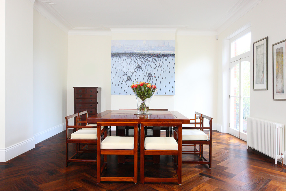 Design ideas for a medium sized contemporary dining room in London with white walls and dark hardwood flooring.