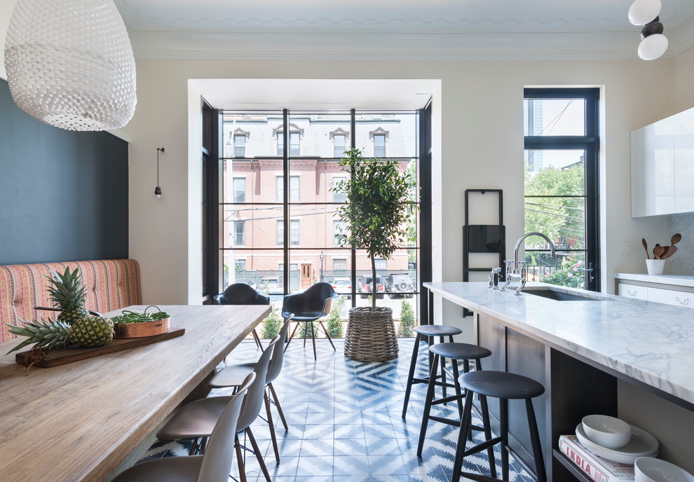 This is an example of a contemporary dining room in Boston with concrete flooring.