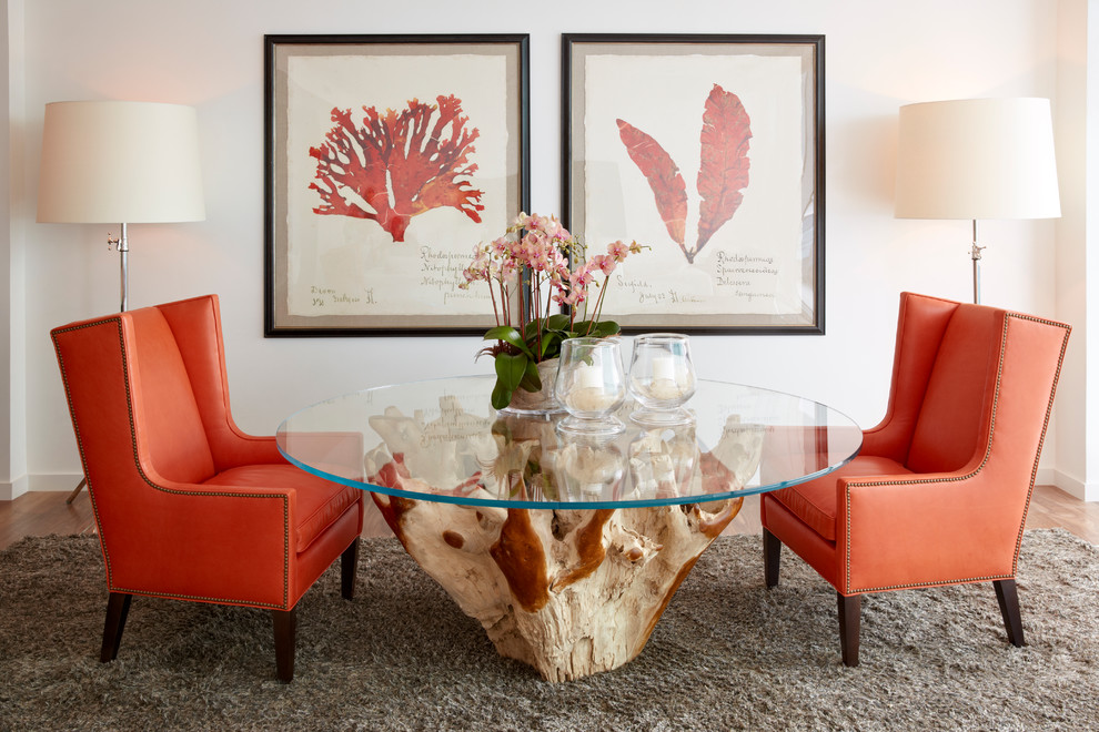 Photo of a world-inspired dining room in Miami with white walls, medium hardwood flooring and feature lighting.