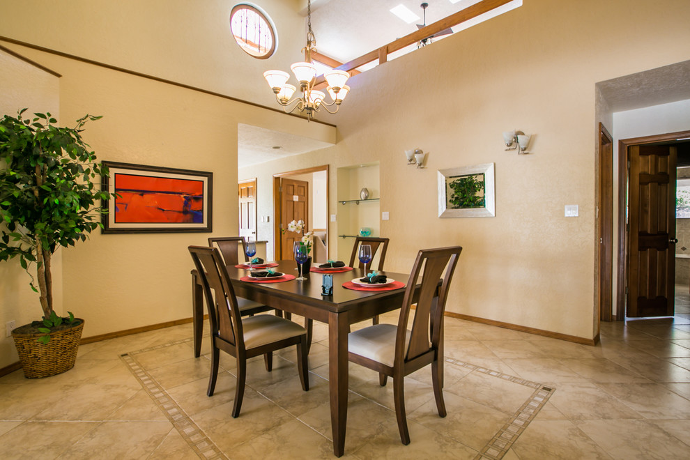Large contemporary dining room in Albuquerque with yellow walls, ceramic flooring and no fireplace.