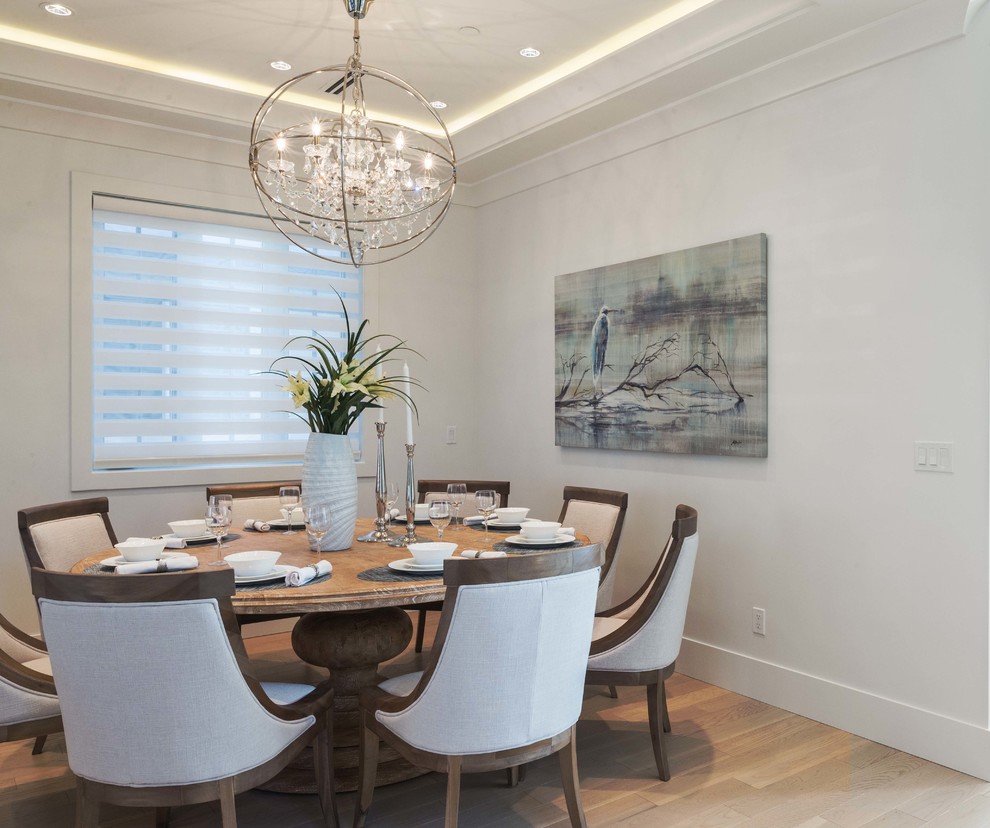 This is an example of a medium sized contemporary open plan dining room in Vancouver with white walls and light hardwood flooring.