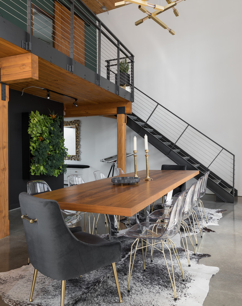 This is an example of a contemporary open plan dining room in Seattle with white walls, concrete flooring and grey floors.
