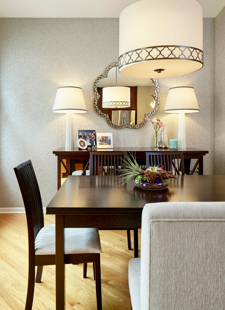 Immagine di una piccola sala da pranzo aperta verso la cucina boho chic con pareti grigie e parquet chiaro