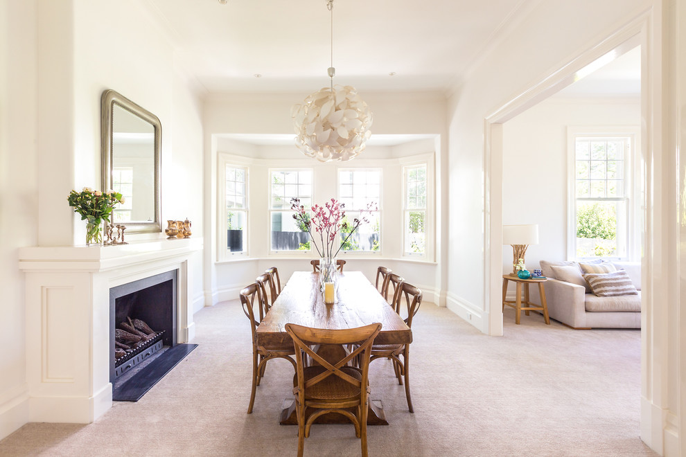 Photo of a large classic dining room in Melbourne with white walls, carpet, a standard fireplace and a metal fireplace surround.
