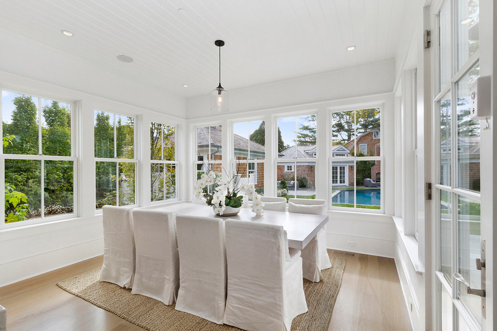 Inspiration pour une salle à manger marine avec un mur blanc et parquet clair.