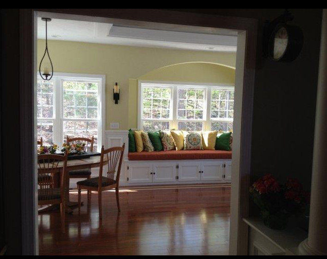 Traditional enclosed dining room in Boston with yellow walls and dark hardwood flooring.
