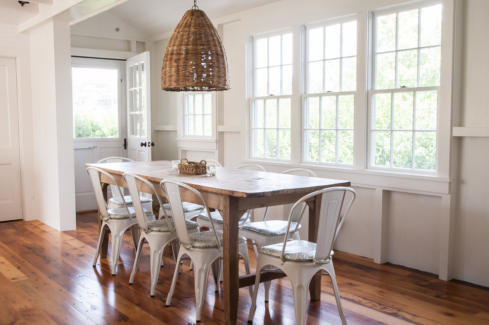 Dining room - mid-sized coastal medium tone wood floor dining room idea in Other with white walls