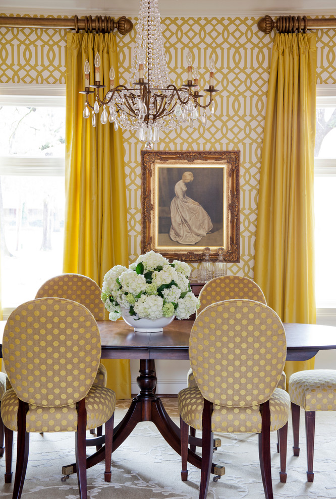 Example of a mid-sized trendy medium tone wood floor dining room design in Little Rock with yellow walls