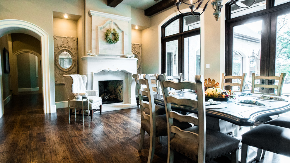 Inspiration for a medium sized classic open plan dining room in Dallas with beige walls, dark hardwood flooring, a standard fireplace, a tiled fireplace surround and brown floors.