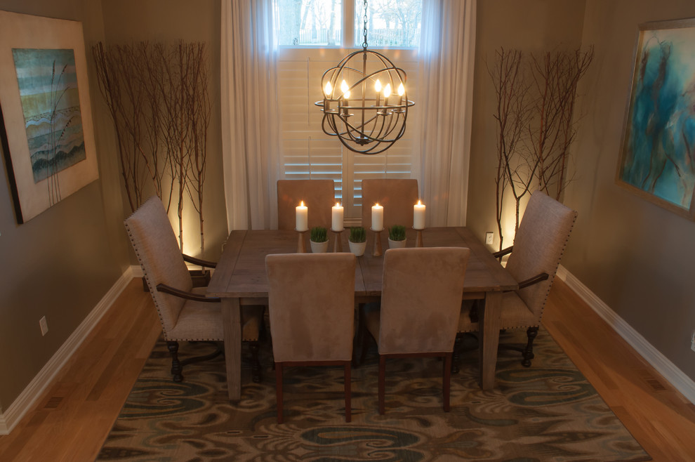 Example of a mid-sized transitional light wood floor enclosed dining room design in Other with beige walls and no fireplace