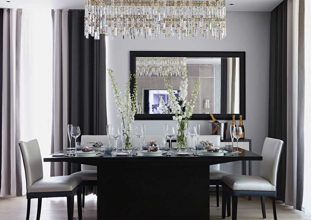 Dining room - transitional light wood floor dining room idea in London with gray walls and no fireplace