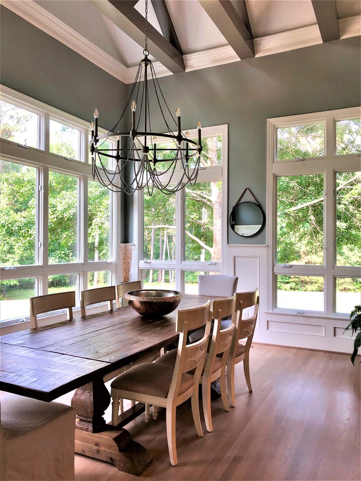 This is an example of a large rural enclosed dining room in Raleigh with green walls, medium hardwood flooring, no fireplace and brown floors.