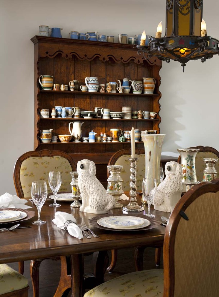 Mountain style dark wood floor enclosed dining room photo in San Diego with white walls