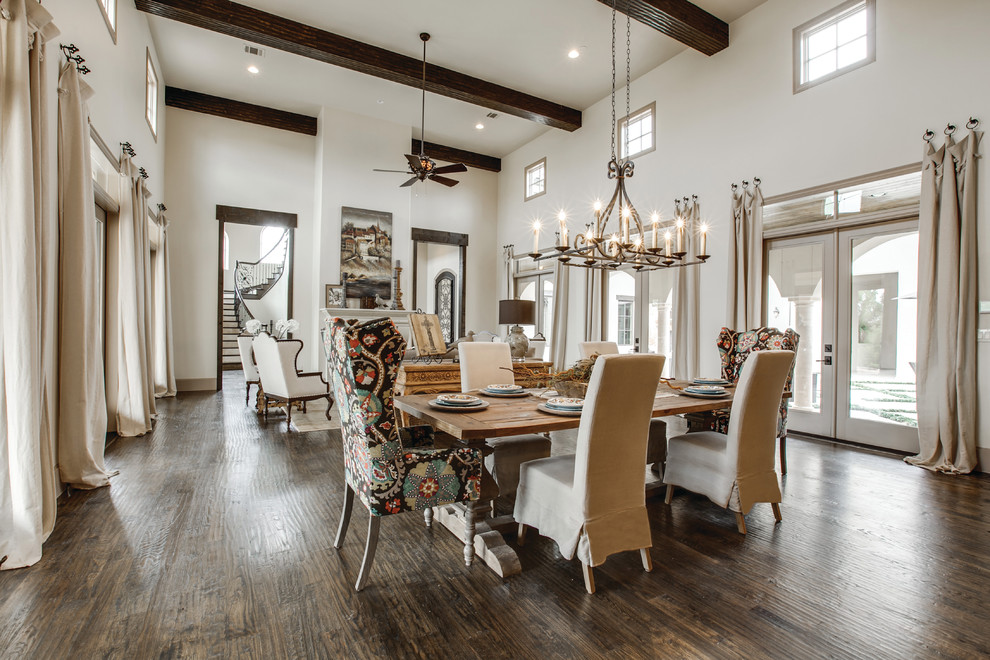 This is an example of an expansive mediterranean open plan dining room in Dallas with beige walls, medium hardwood flooring and feature lighting.
