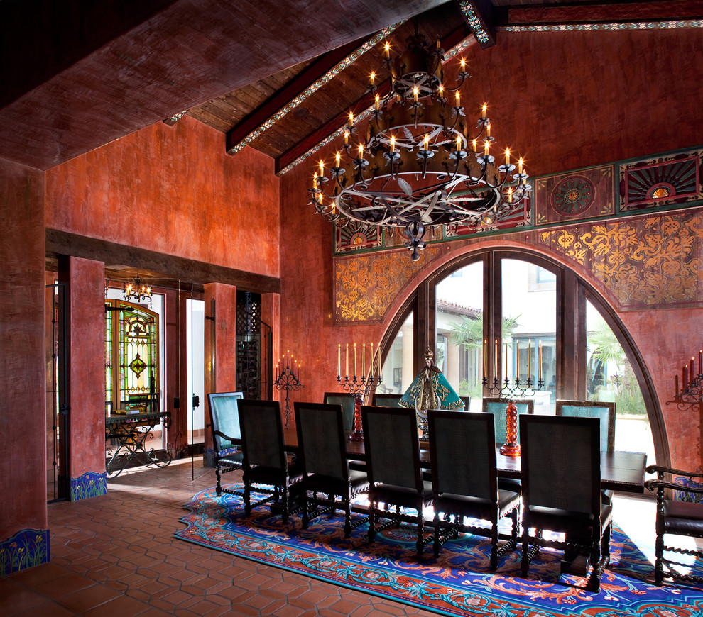 Photo of a large mediterranean enclosed dining room in Tampa with no fireplace and red walls.