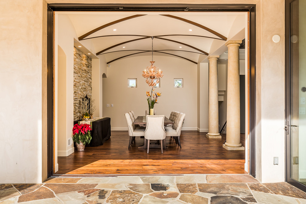 Inspiration for a large mediterranean medium tone wood floor dining room remodel in Los Angeles with white walls