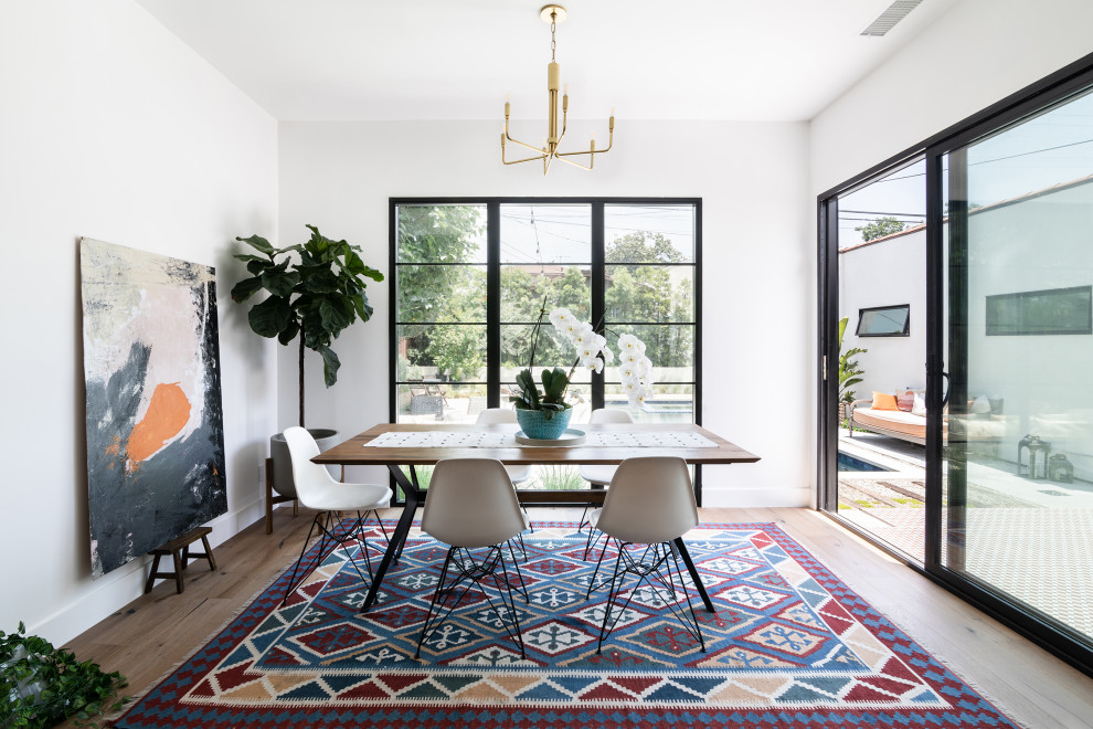 Inspiration for a mid-sized mediterranean medium tone wood floor and brown floor kitchen/dining room combo remodel in Los Angeles with white walls