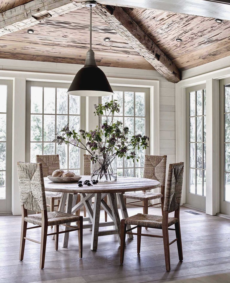 Inspiration for a coastal light wood floor and beige floor dining room remodel in Other