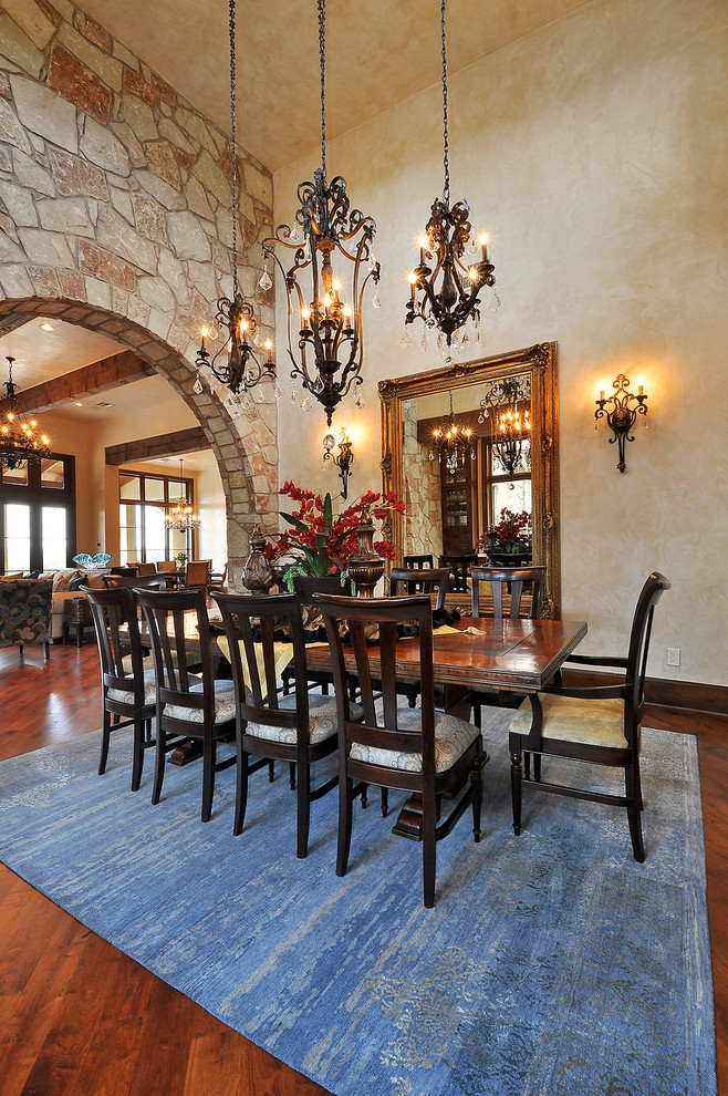 Inspiration for a large timeless medium tone wood floor great room remodel in Austin with beige walls and no fireplace