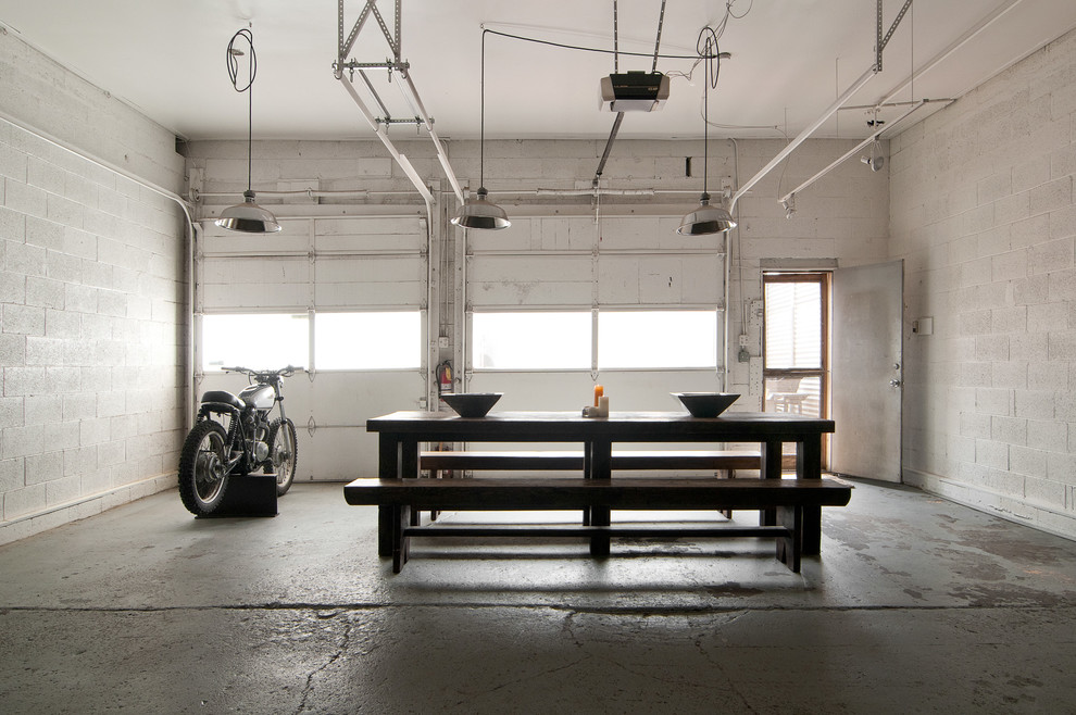 Inspiration for an industrial dining room remodel in Salt Lake City with white walls