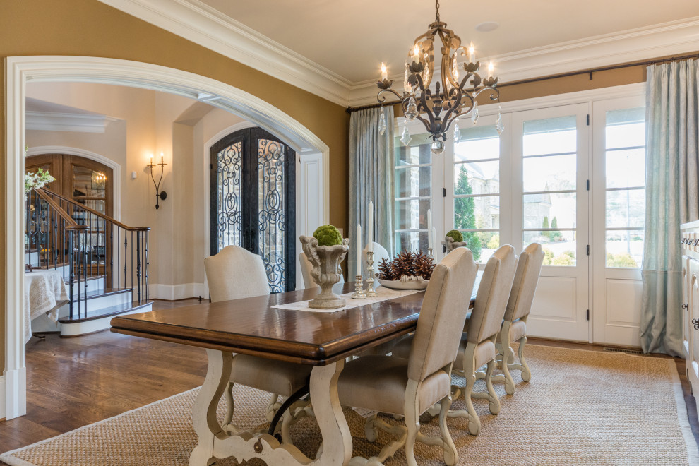 Example of a large french country medium tone wood floor and tray ceiling dining room design in Atlanta with brown walls
