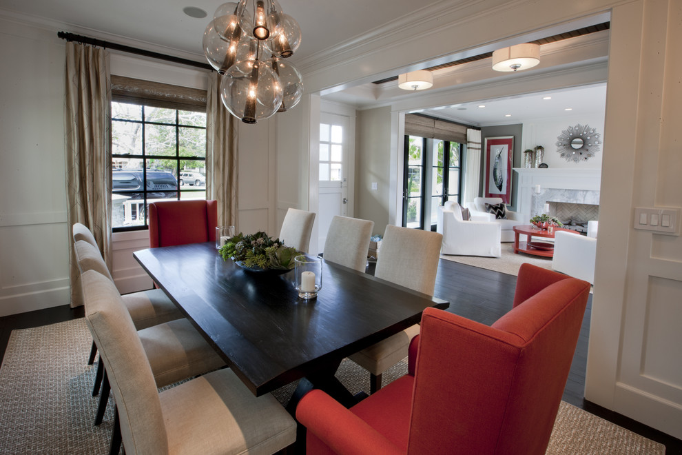 Traditional dining room in Orange County with white walls, dark hardwood flooring and feature lighting.
