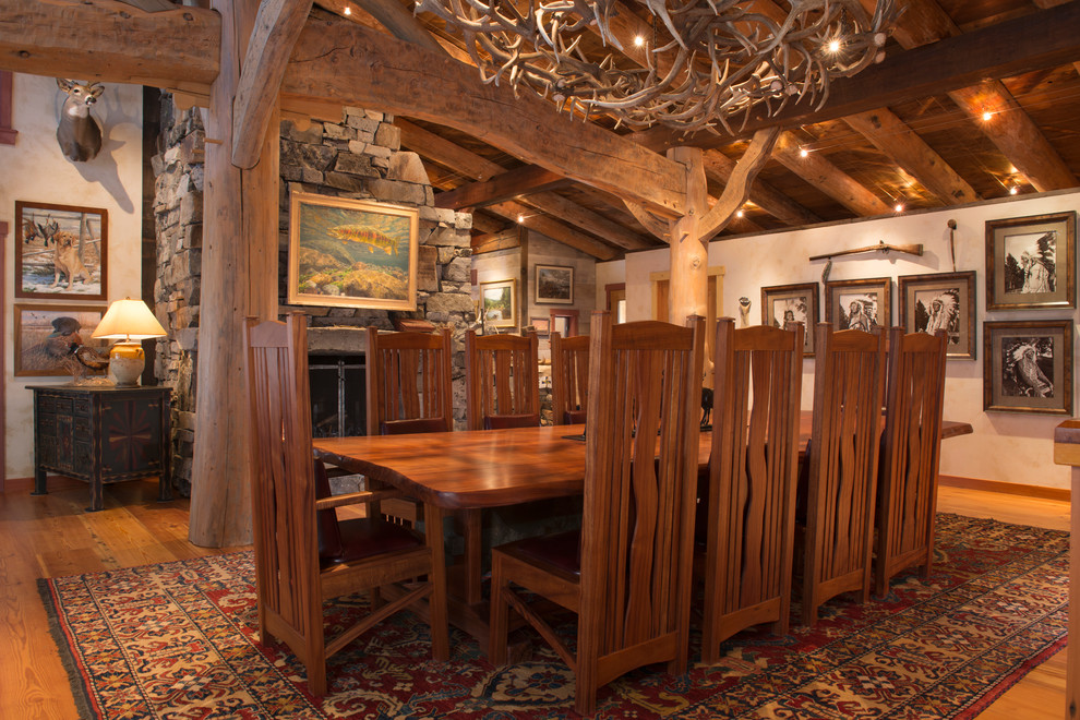 Rustic dining room in Other with feature lighting.