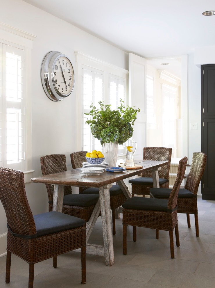 Example of a beach style dining room design in New York with white walls