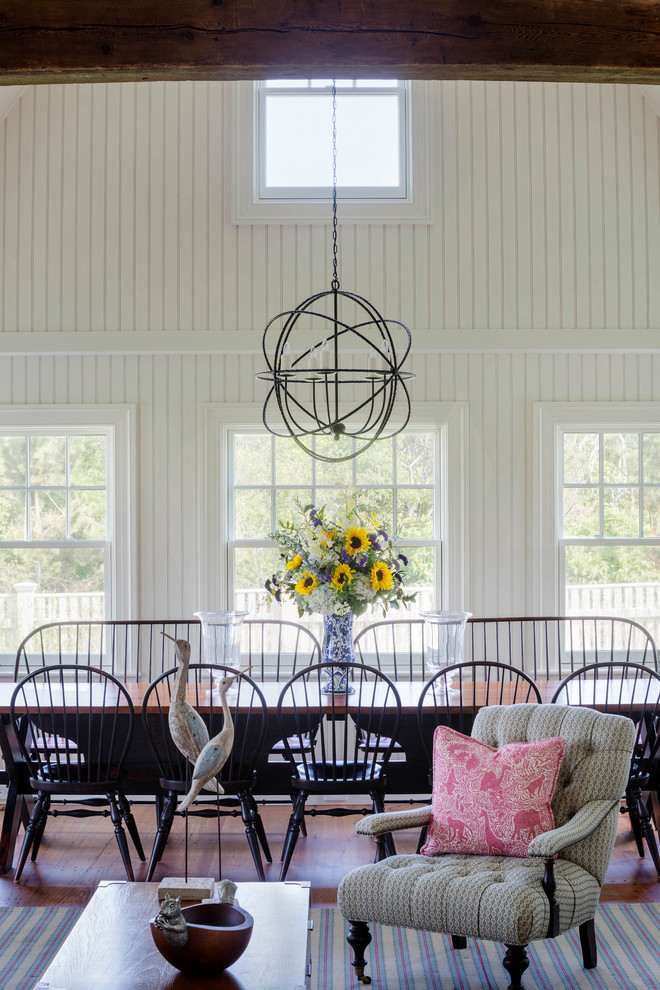 This is an example of a large rural open plan dining room in Boston with white walls, medium hardwood flooring and no fireplace.